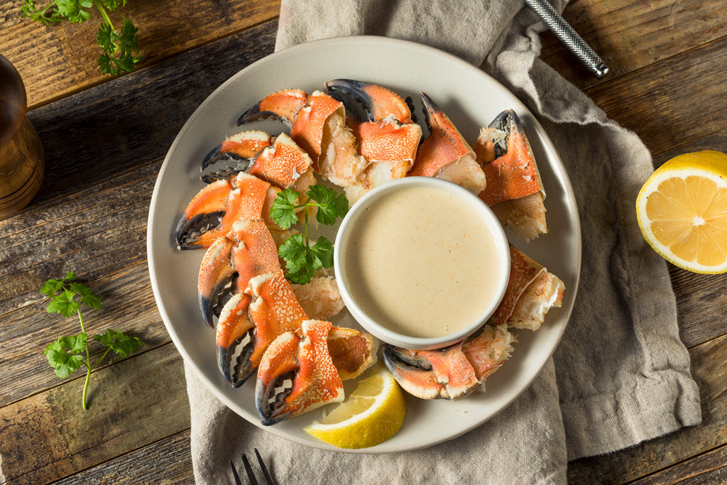 Stone crab claws on plate with lemon and horseradish sauce