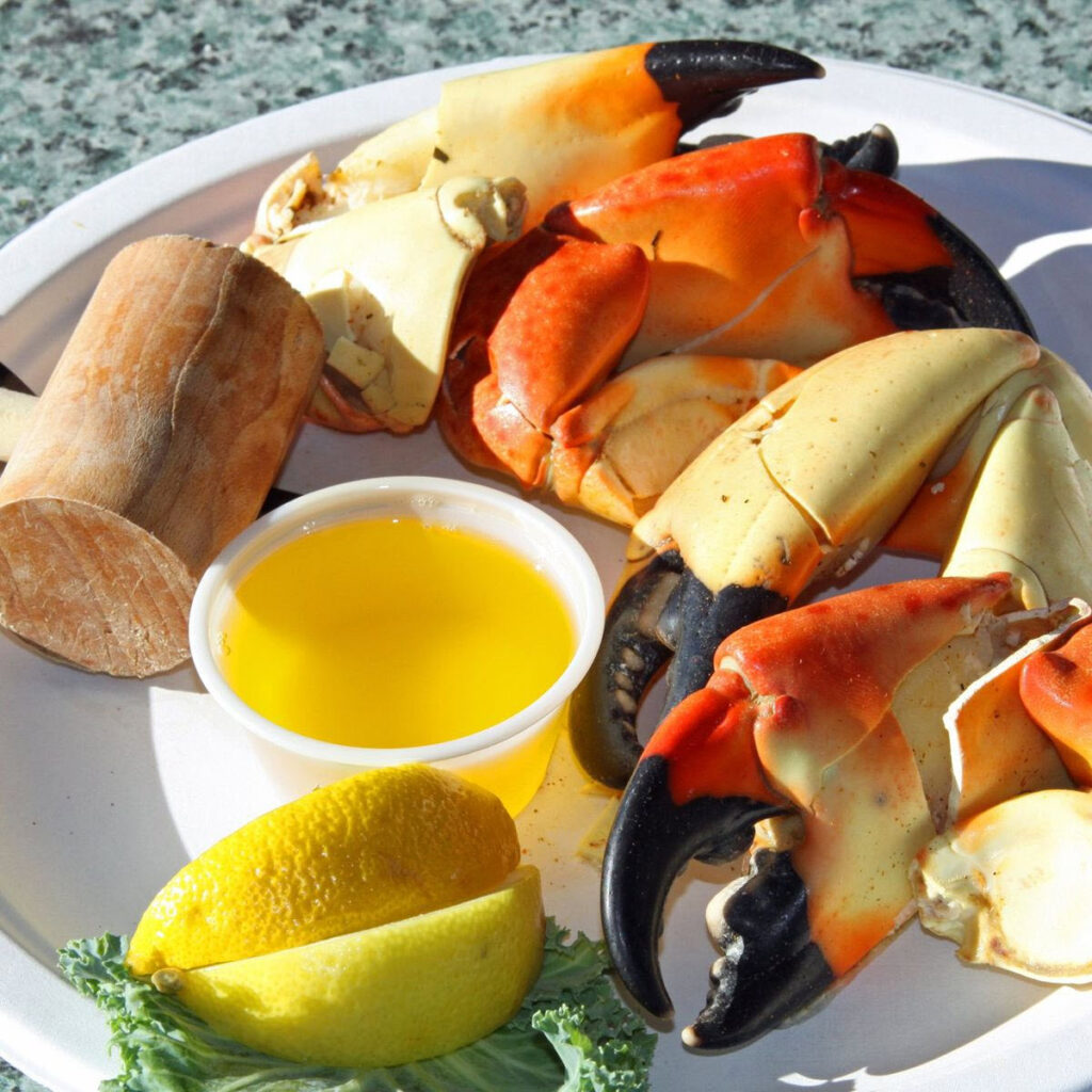 Stone crab on a plate with lemons and butter