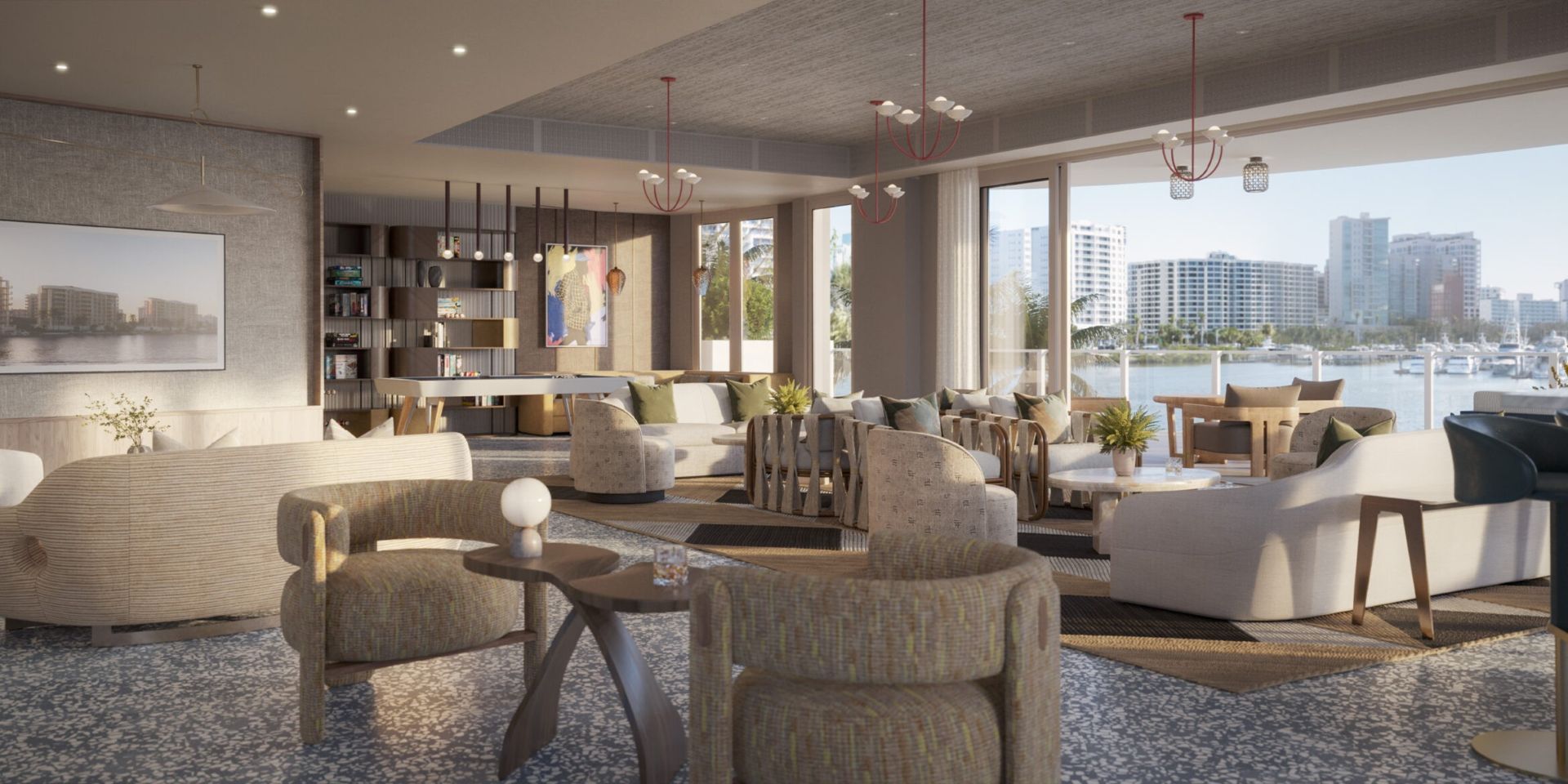 Resident social lounge at Amara on Sarasota Bay featuring comfortable seating areas, refined contemporary design, and expansive windows overlooking the marina and Sarasota Bay.