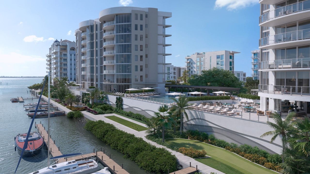 Elevated view of Amara residences overlooking Bayfront Park and the Marina District, featuring waterfront promenades, private docks, landscaped green spaces, and Sarasota Bay in the background.