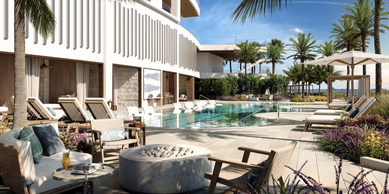 Beach-level lounge with comfortable seating and an outdoor firepit, surrounded by palm trees and modern coastal architecture.