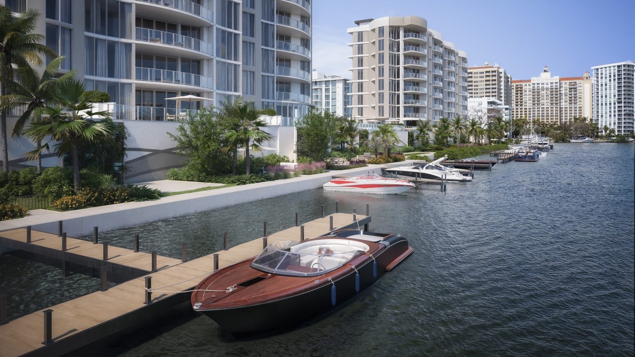 Waterfront residences with private marina docks, showcasing direct boating access on Sarasota Bay with luxury boats moored alongside the shoreline.