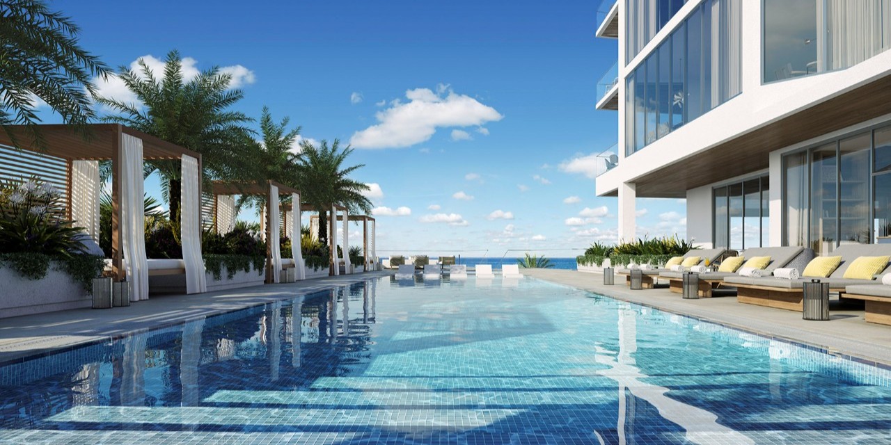 Oceanfront resort-style pool with contemporary design, elegant loungers, and open views of the Gulf in a luxury residential setting.