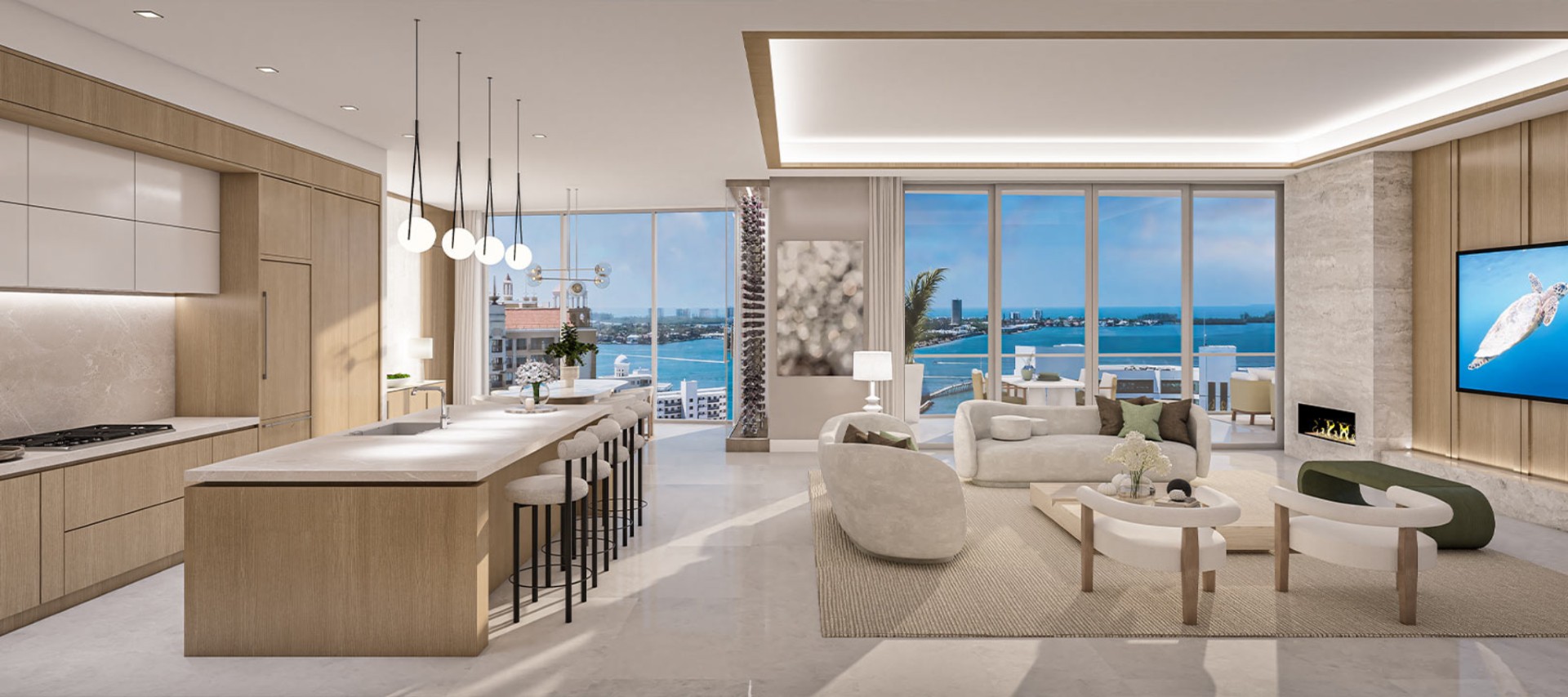 Contemporary chef’s kitchen and great room at The Ritz-Carlton Residences Sarasota Bay with large island, custom cabinetry, and waterfront views through floor-to-ceiling windows.