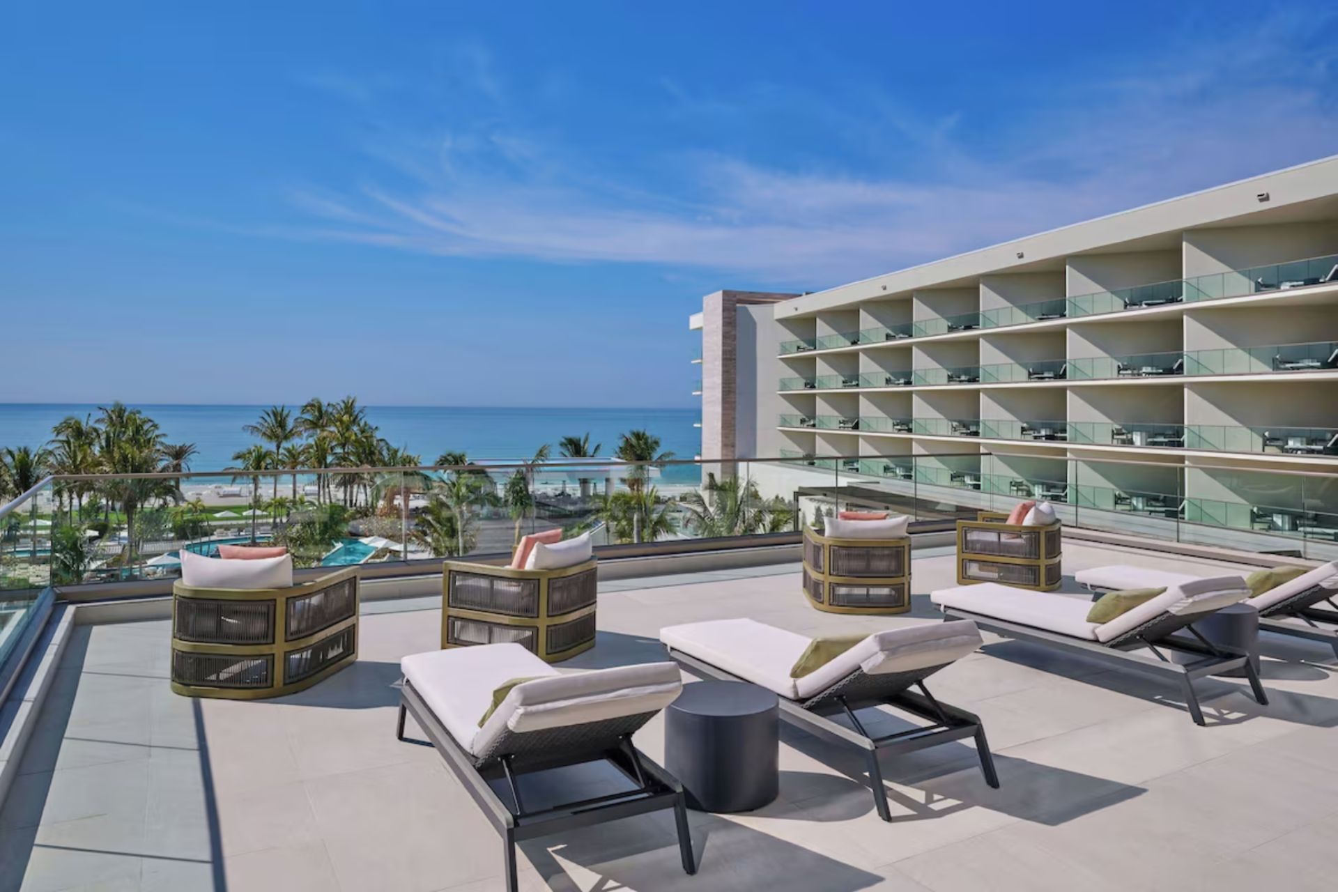 Elevated outdoor sun deck with luxury loungers overlooking the Gulf of Mexico at St. Regis Residences Longboat Key.