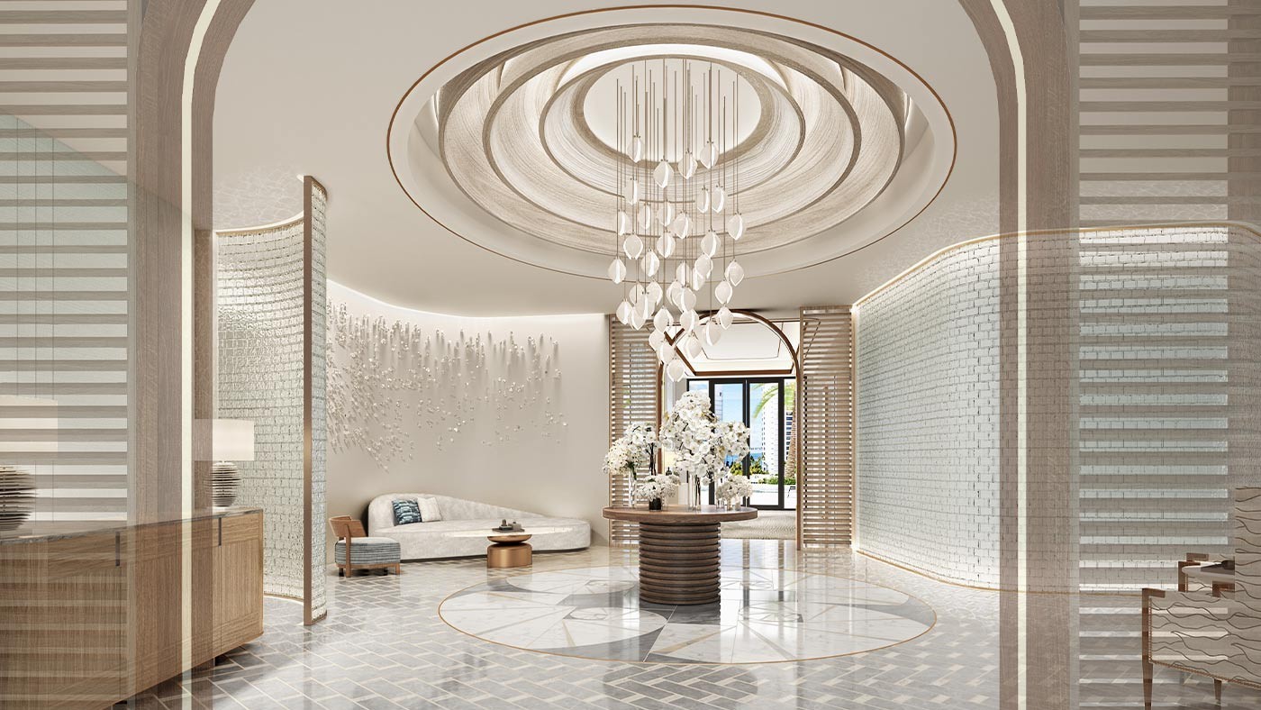 Elegant grand salon lobby at The Ritz-Carlton Residences Sarasota Bay featuring a circular chandelier, refined seating areas, and a dramatic luxury arrival experience.