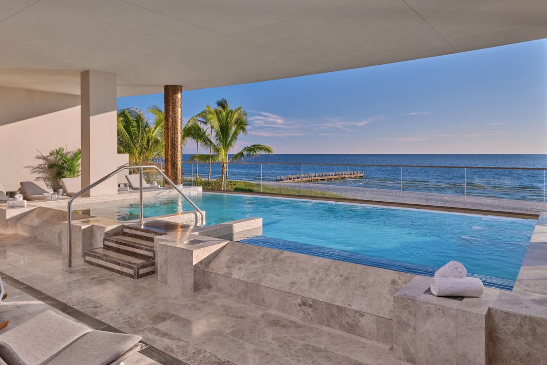 Saltwater lagoon with cascading waterfall at St. Regis Longboat Key offering a resort-style aquatic experience surrounded by tropical landscaping.