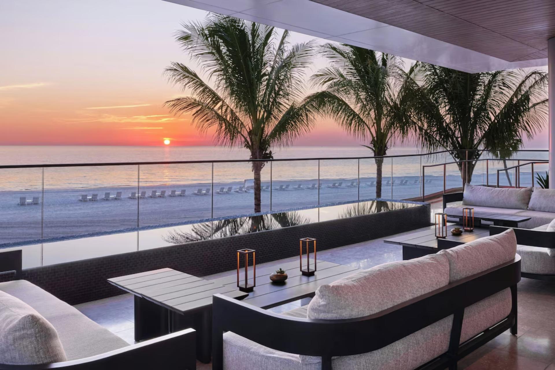 Sunset view from an elevated outdoor lounge overlooking the Gulf of Mexico and private beachfront at St. Regis Longboat Key.