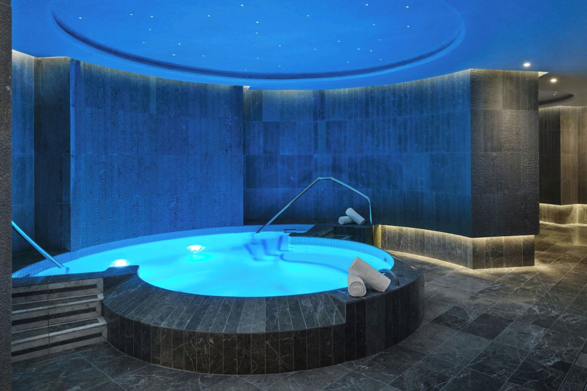 Indoor hydrotherapy pool with ambient lighting at the spa of St. Regis Residences Longboat Key