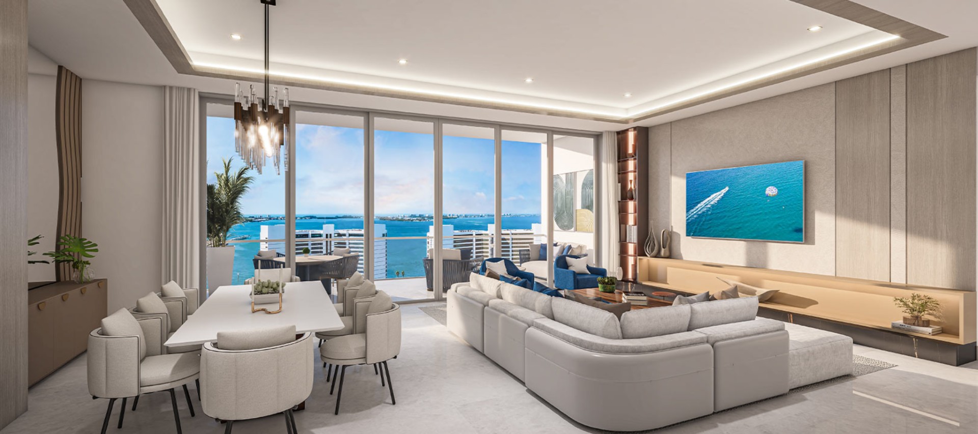 Open-plan dining and living area at The Ritz-Carlton Residences Sarasota Bay featuring modern finishes, custom lighting, and floor-to-ceiling windows with bay views.