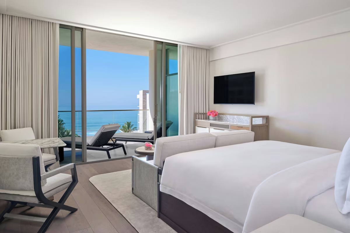 Primary bedroom at St. Regis Longboat Key Residences featuring a private sitting area, modern finishes, and direct views of the Gulf of Mexico.