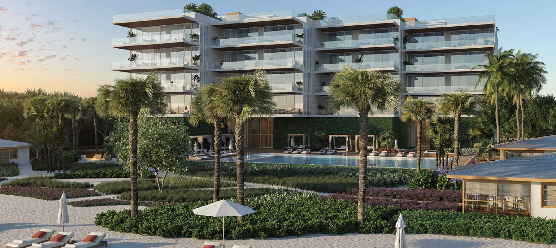 Rear beachfront view of Sage Residences on Longboat Key featuring a resort-style pool, private cabanas, palm-lined landscaping, and modern Gulf-front condominium residences with expansive glass balconies at sunset.