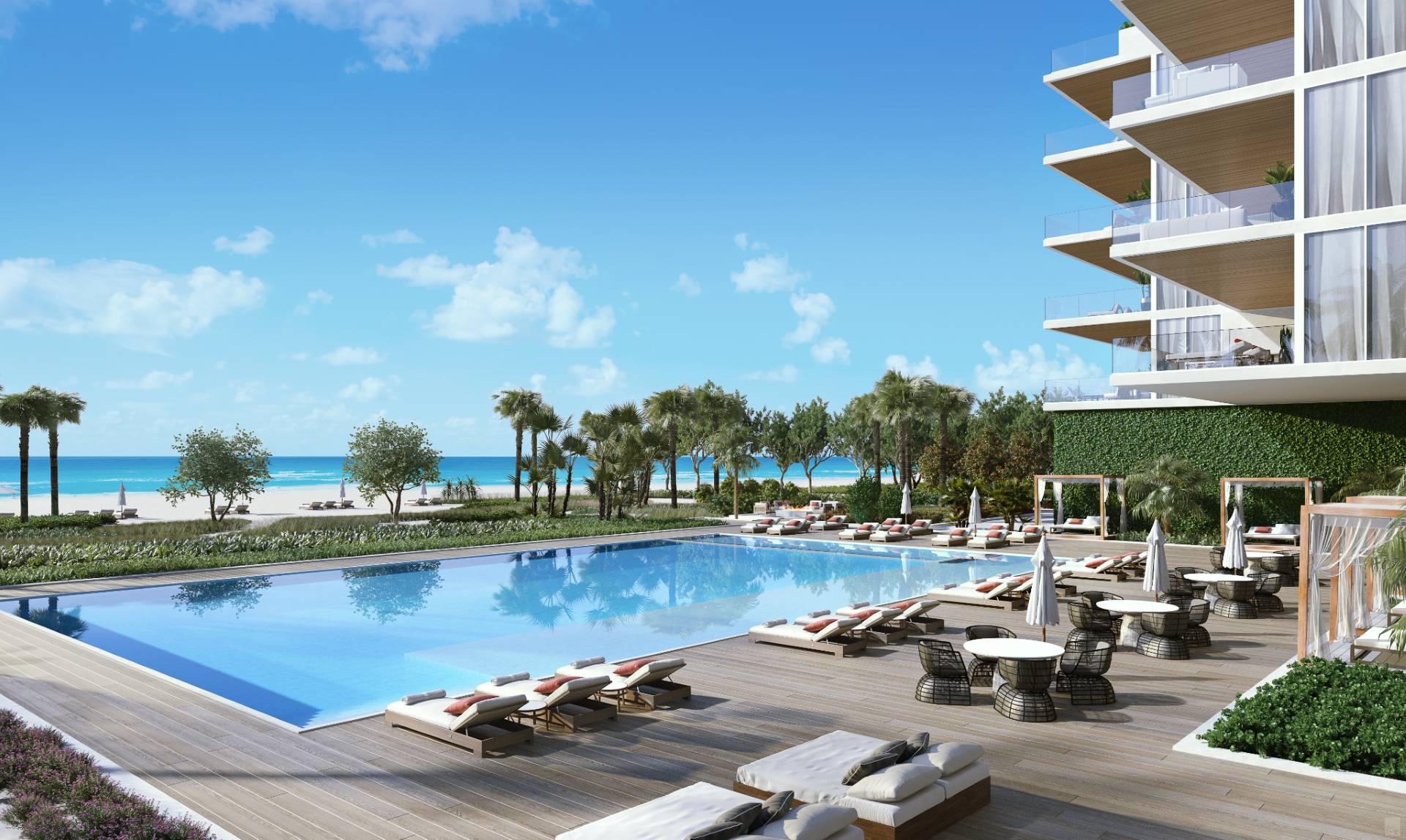 Resort-style beachfront pool at Sage Residences on Longboat Key featuring expansive sun deck, private cabanas, palm-lined landscaping, and direct views of the Gulf of Mexico.