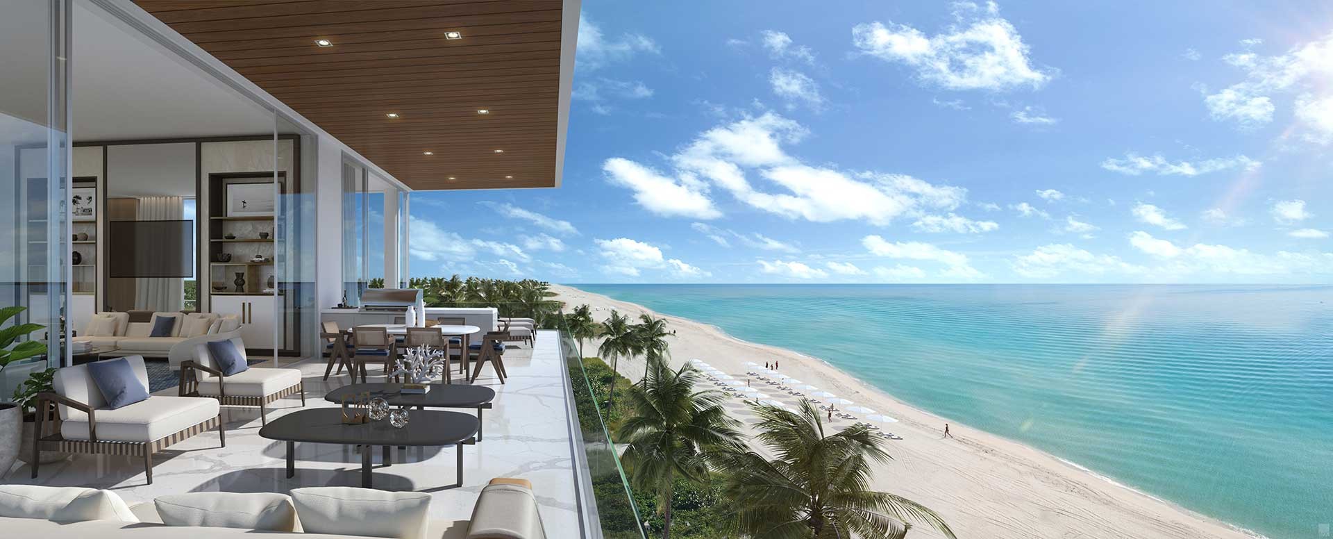 Expansive private balcony at Sage Residences on Longboat Key overlooking white sand beaches and turquoise Gulf waters, with outdoor lounge and dining space framed by glass railings.