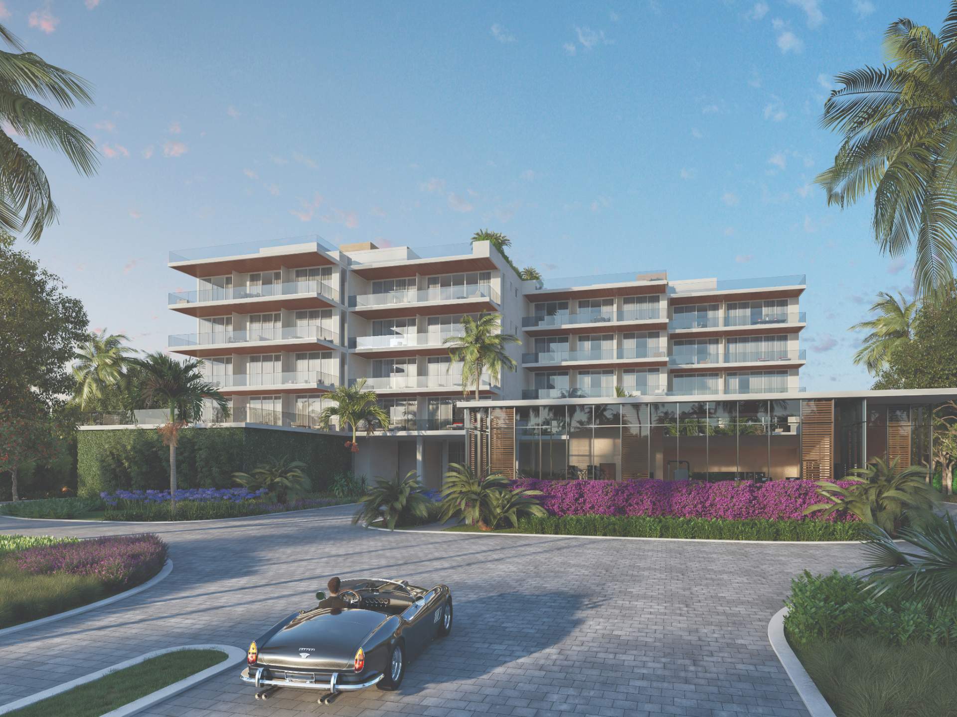 Front arrival view of Sage Residences on Longboat Key showcasing contemporary architecture, landscaped motor court, covered porte-cochere entrance, and luxury beachfront condominium design.
