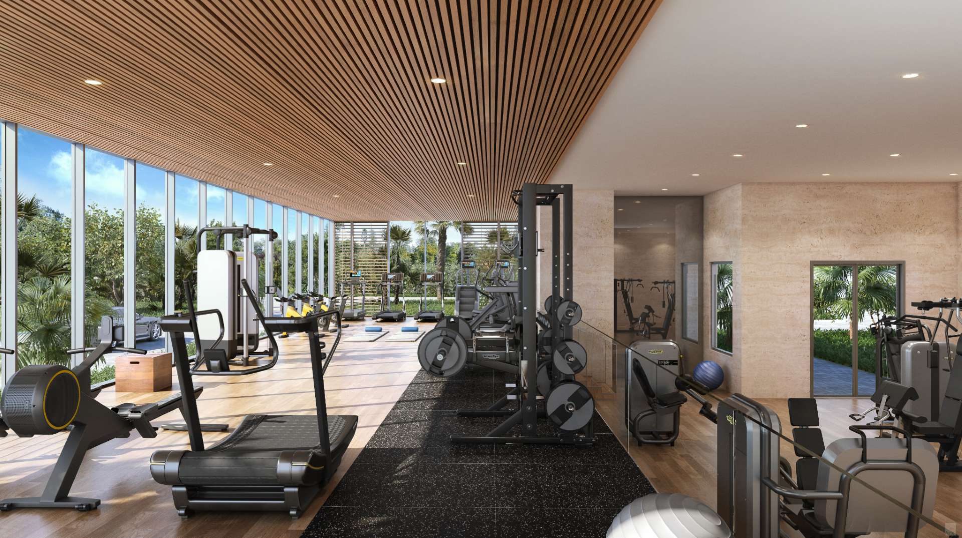 Modern fitness center at Sage Residences on Longboat Key with strength equipment, cardio machines, floor-to-ceiling windows, and landscaped garden views.