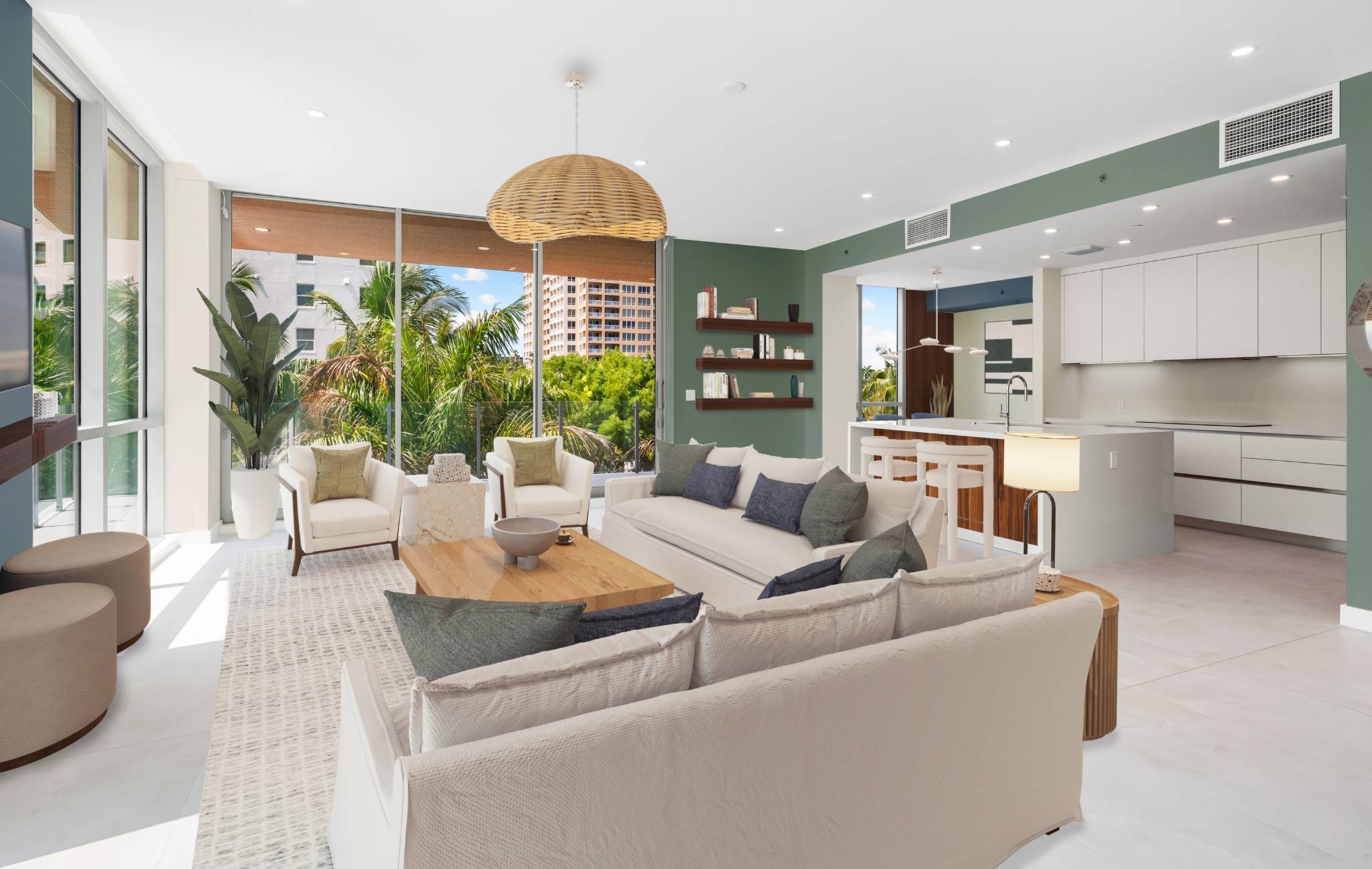 Open-concept living room featuring designer shelving, contemporary kitchen, and floor-to-ceiling windows with tropical views
