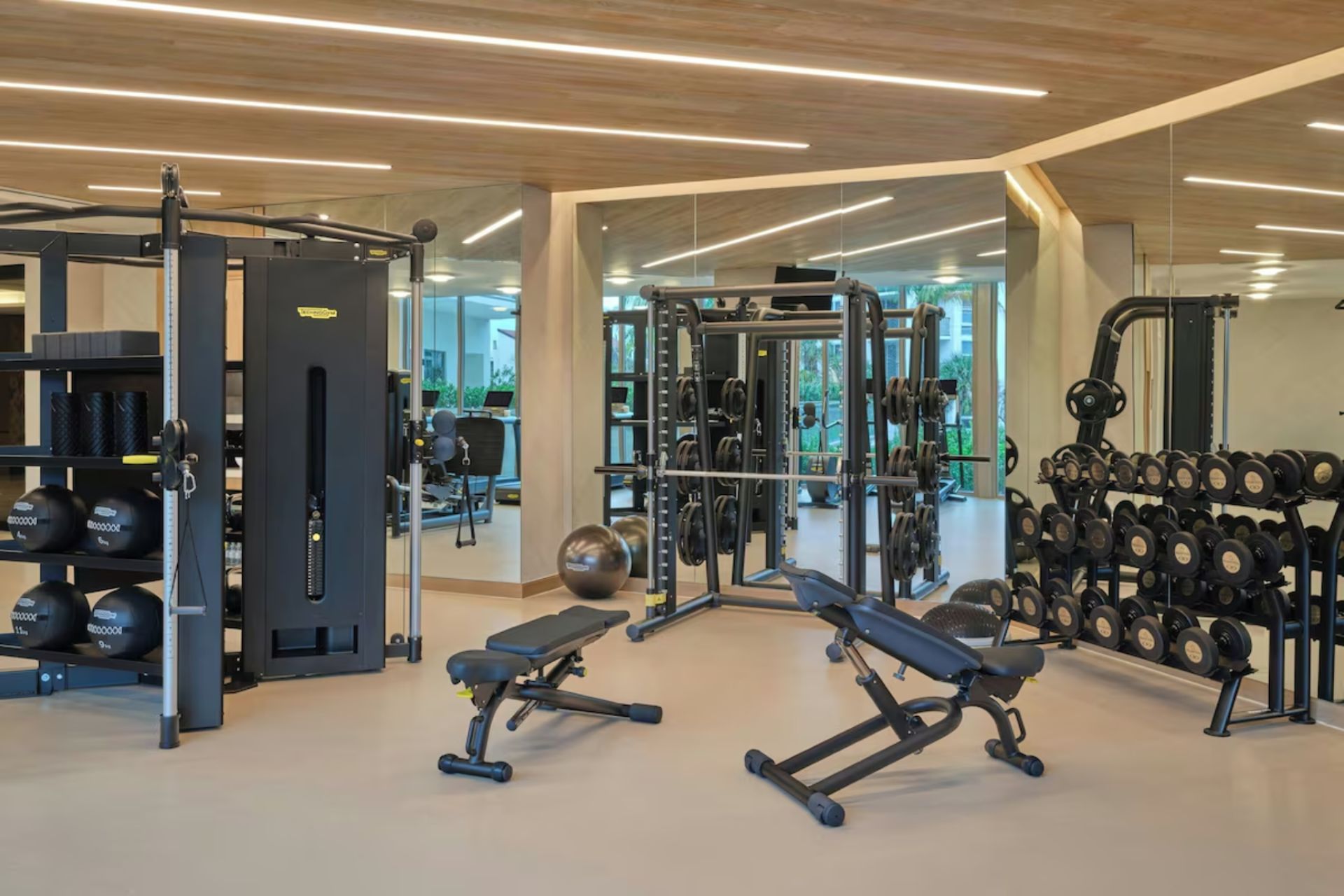 Modern fitness center with strength training equipment and free weights at St. Regis Residences Longboat Key