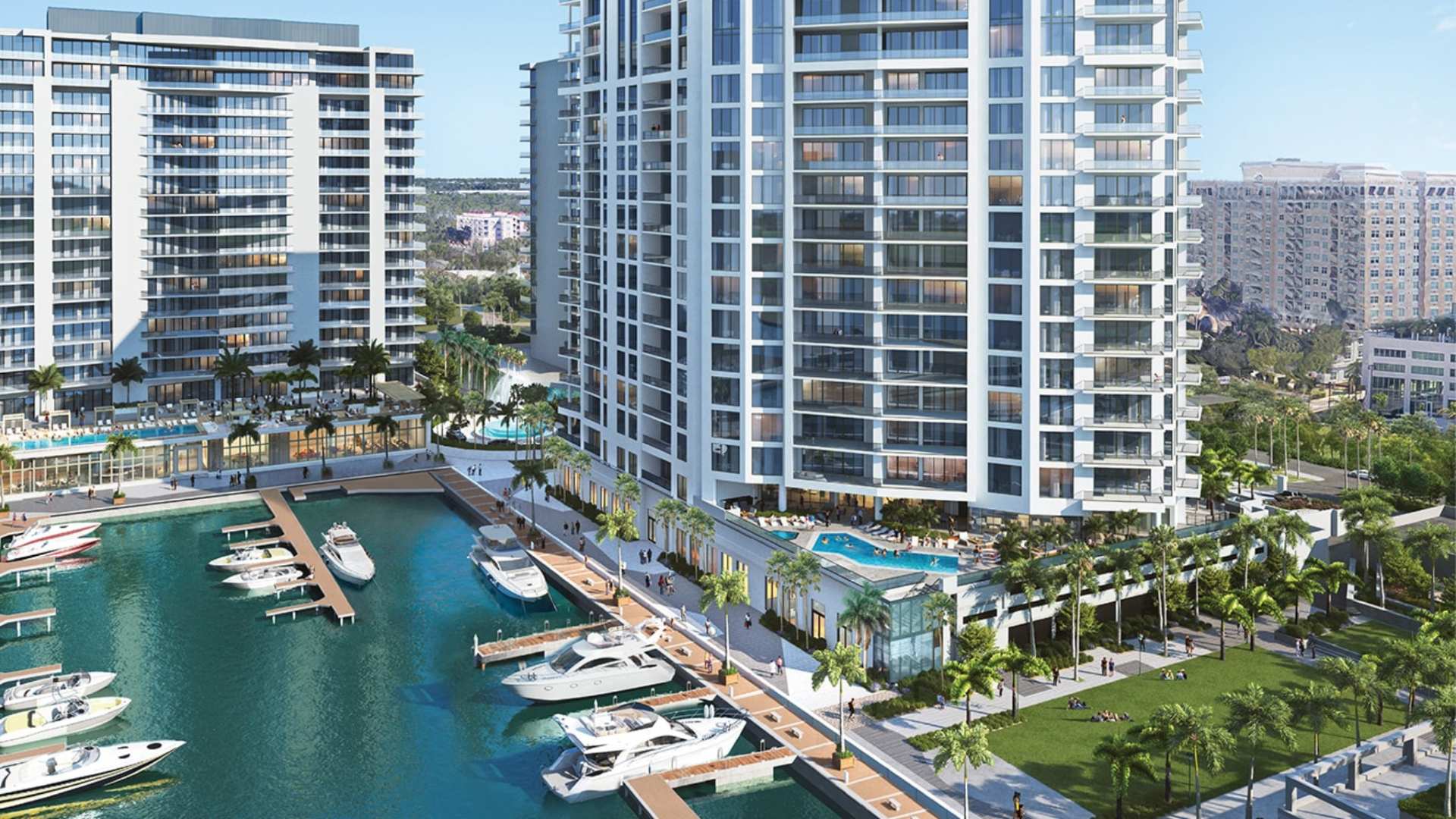 The Harbor Club at The Ritz-Carlton Residences Sarasota Bay overlooking the private marina with waterfront promenade, resort-style amenities, and luxury residential towers.