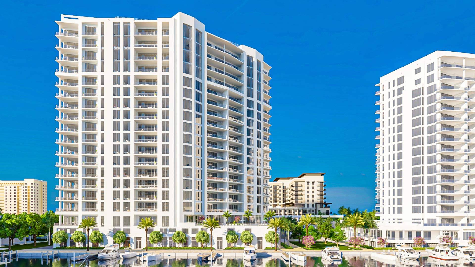 Waterfront residential towers and private marina at The Ritz-Carlton Residences Sarasota Bay with yacht slips and landscaped waterfront promenade.
