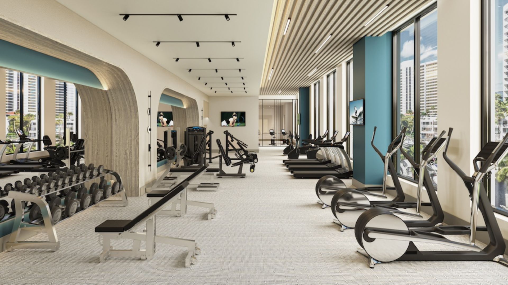 State-of-the-art wellness and fitness center at The Ritz-Carlton Residences Sarasota Bay featuring cardio equipment, strength training area, and floor-to-ceiling windows with waterfront views.