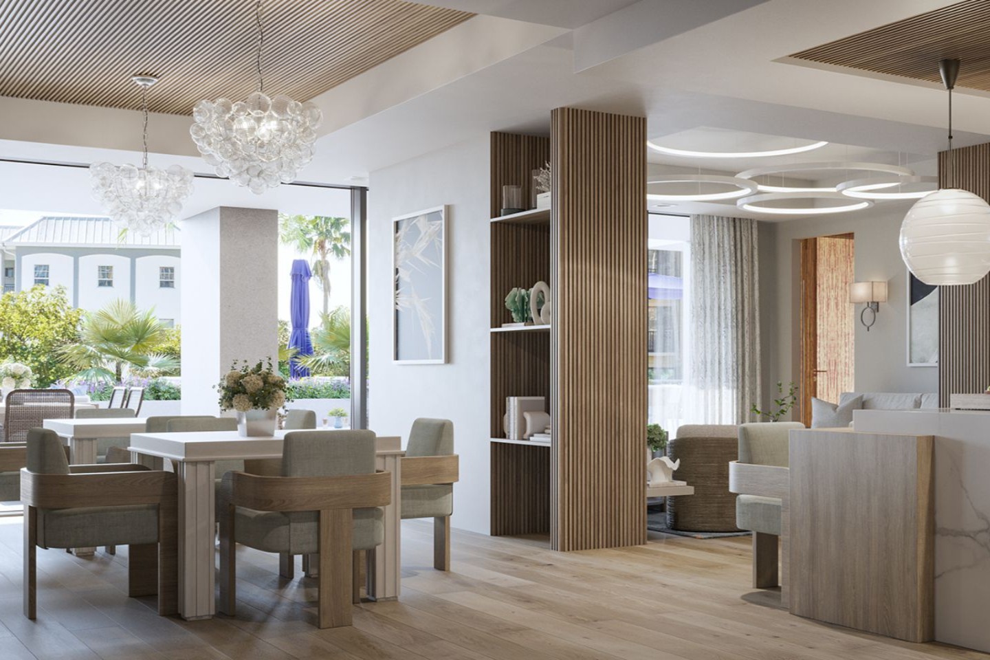 Open-concept social lounge at The Owen Sarasota with modern finishes, dining area, and seamless access to outdoor amenities.
