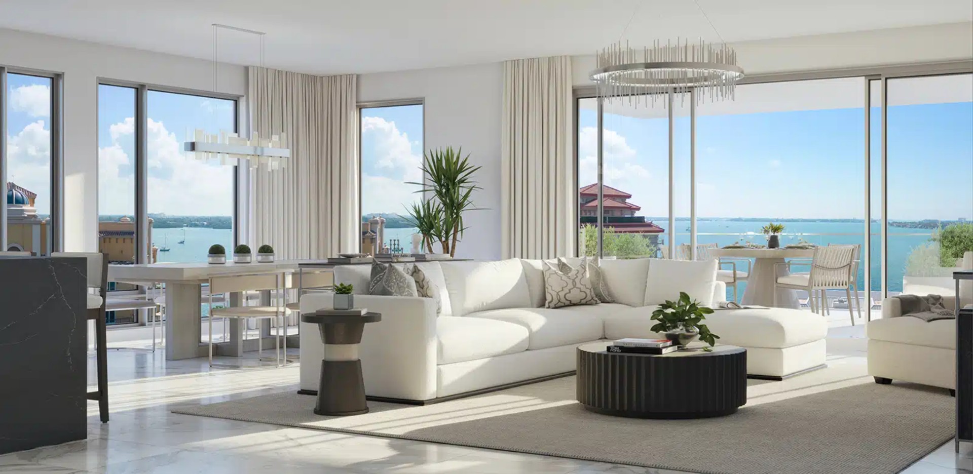 Corner residence at The Owen Sarasota showcasing floor-to-ceiling windows, expansive bay views, modern living area, and natural light throughout.