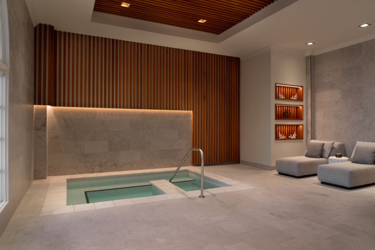 Elegant spa relaxation area with soaking pool and lounge seating at The Ritz-Carlton Sarasota, designed for wellness and tranquility