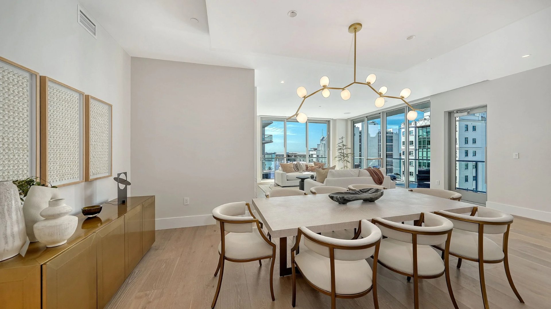 Open-concept luxury dining and living area with floor-to-ceiling windows and waterfront views at Peninsula Sarasota