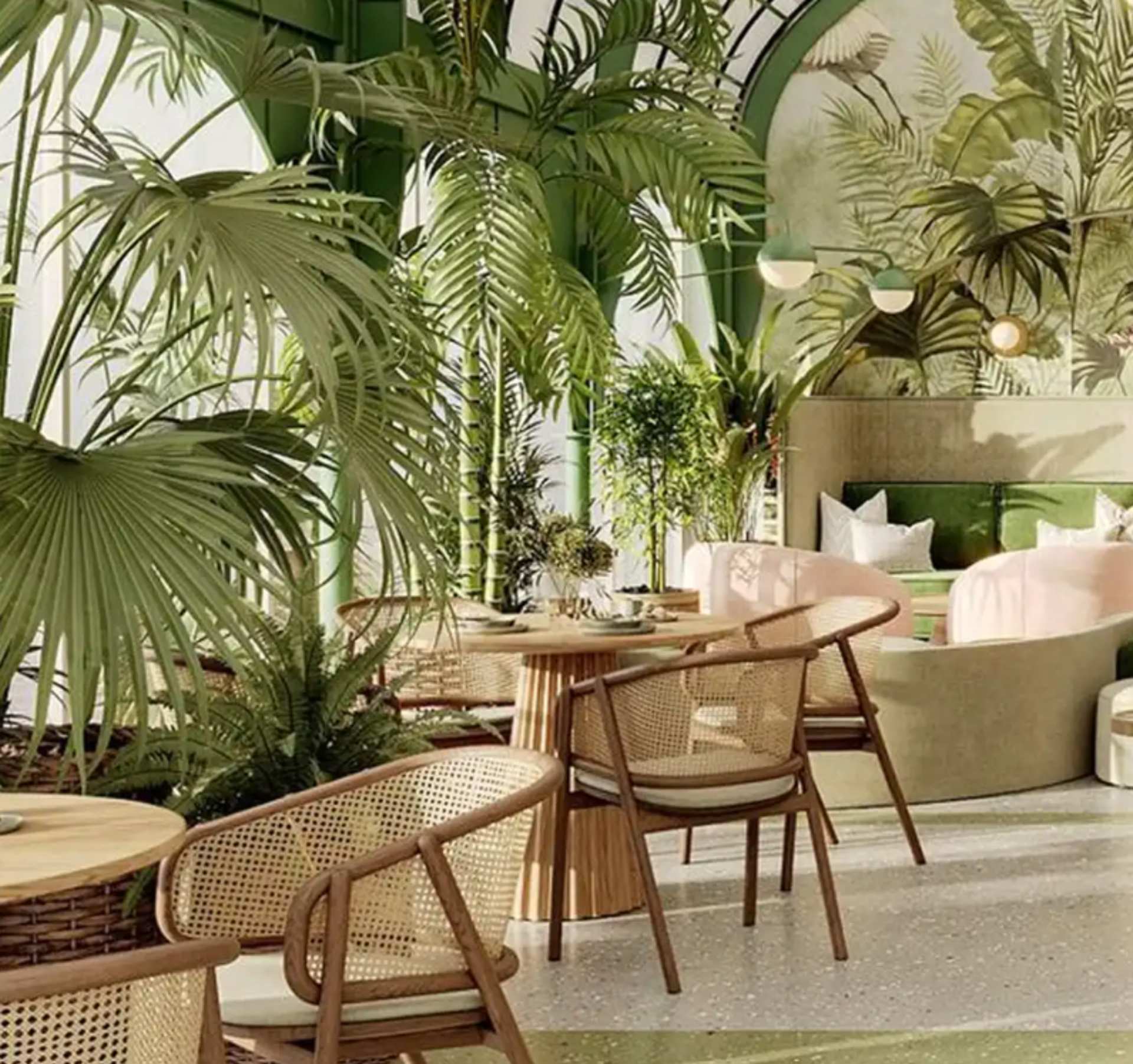Garden lounge at Mira Mar Residences Sarasota featuring lush greenery, natural textures, and relaxed indoor-outdoor seating areas.