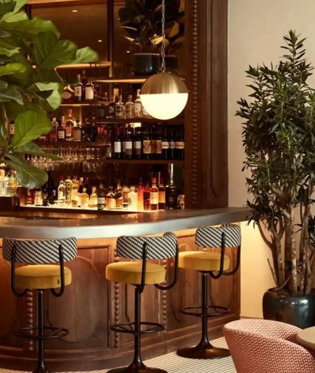 Private bar lounge at Mira Mar Residences Sarasota featuring a curated bar, elegant seating, and a warm, upscale social atmosphere.