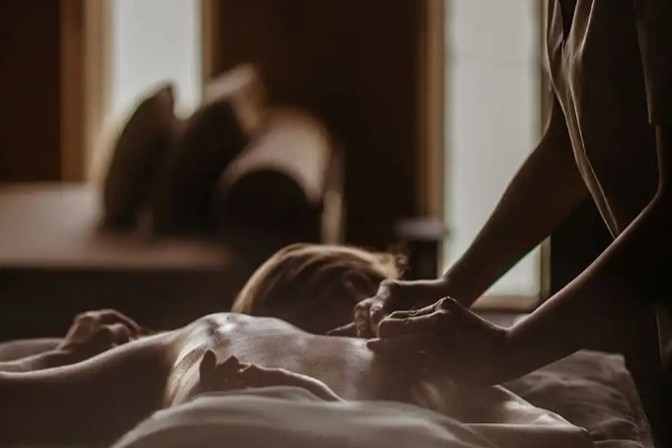 Wellness retreat at Mira Mar Residences Sarasota featuring a tranquil spa setting with massage treatment and calming ambient lighting.