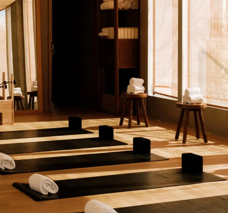 Wellness studio at Mira Mar Residences Sarasota with yoga mats, natural light, and a calm, minimalist fitness environment.