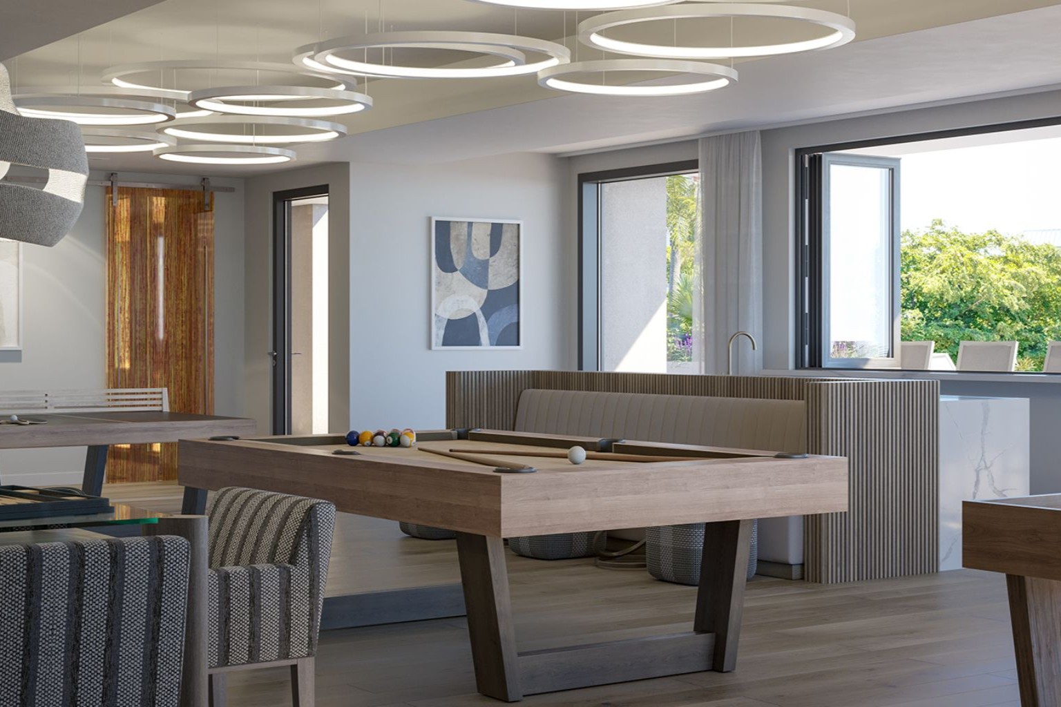 Resident lounge at The Owen Sarasota with billiards table, designer lighting, and comfortable seating for social gatherings and relaxation.