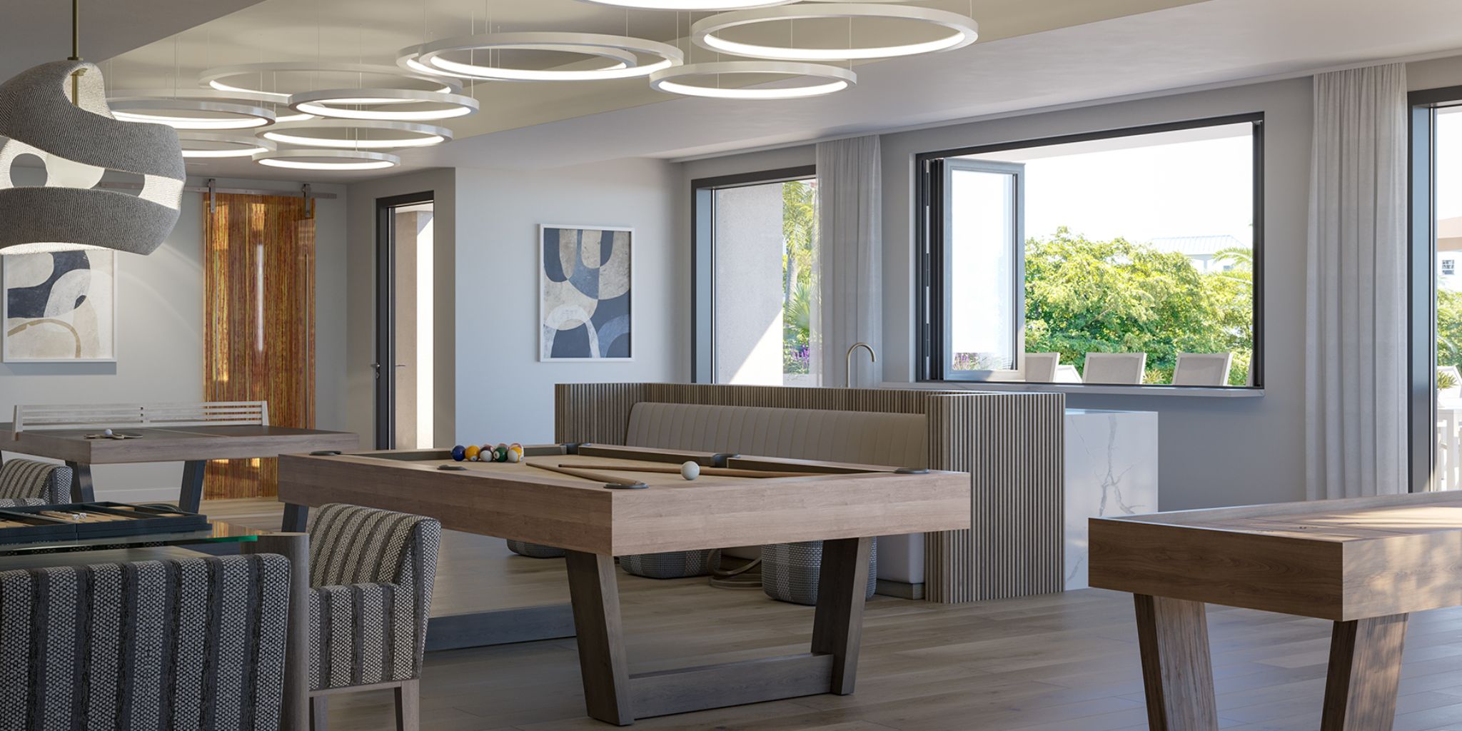 Resident lounge at The Owen Sarasota with billiards table, designer lighting, and comfortable seating for social gatherings and relaxation.