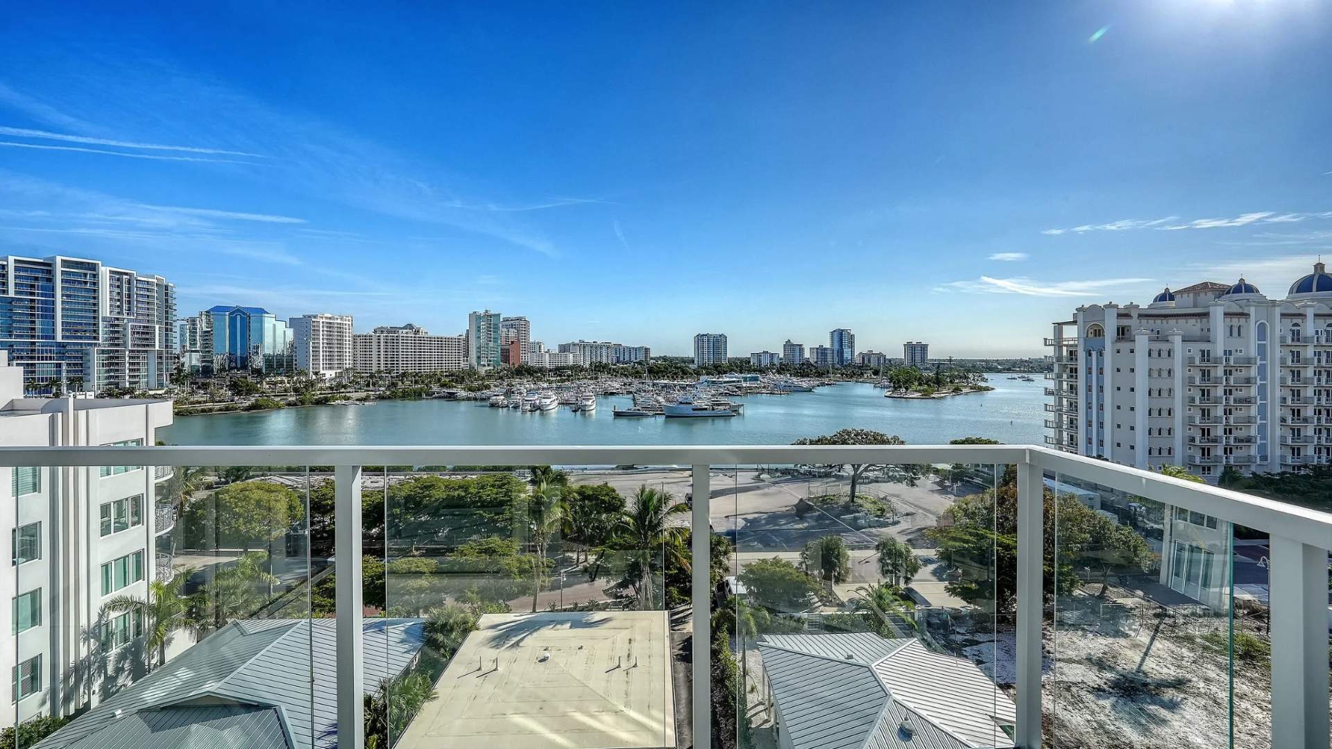 Glass balcony with panoramic views of Sarasota Bay and surrounding skyline from Peninsula Sarasota residence