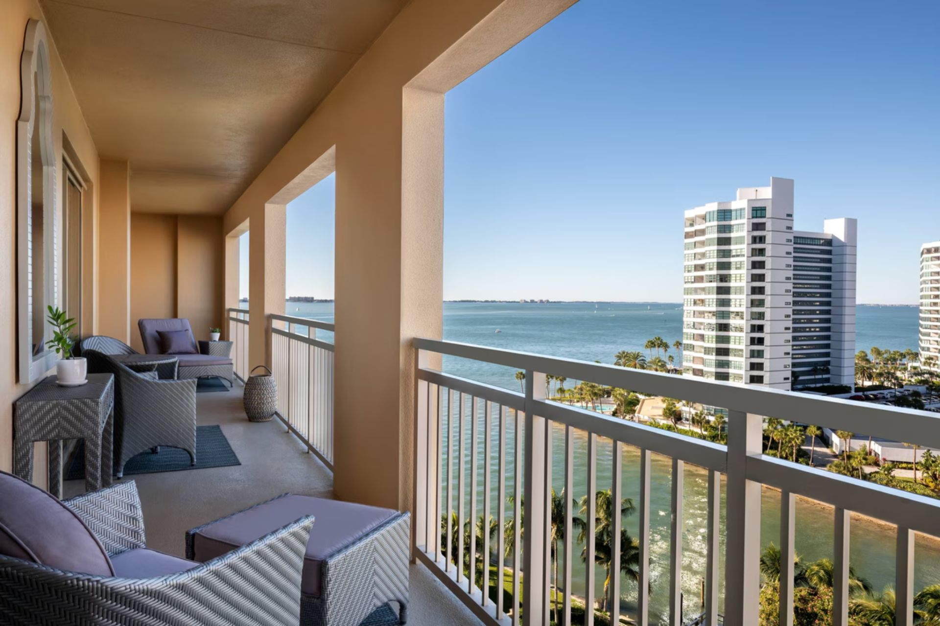 Private balcony with seating overlooking Sarasota Bay and waterfront skyline at The Ritz-Carlton Residences Sarasota