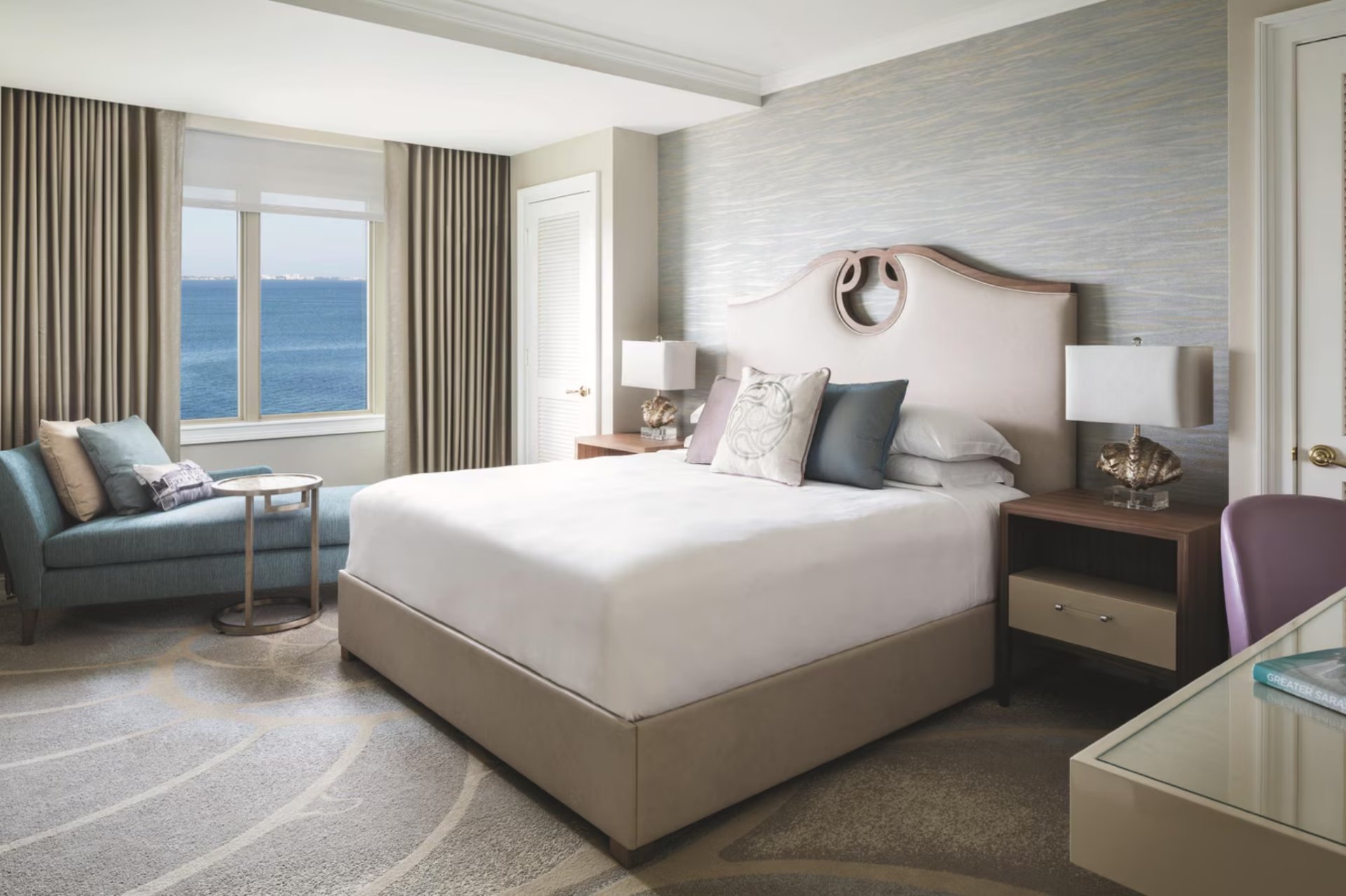 Luxury bedroom with king bed and waterfront views at The Ritz-Carlton Residences Sarasota