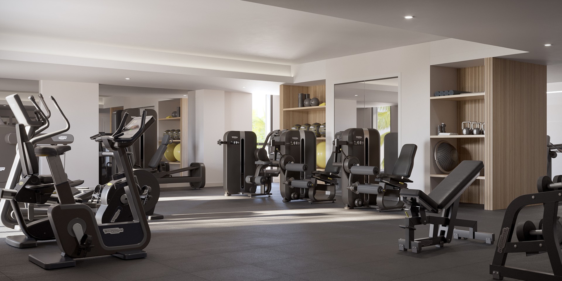 Modern fitness center at The Owen Sarasota featuring strength training equipment, cardio machines, and a clean, well-lit workout environment.