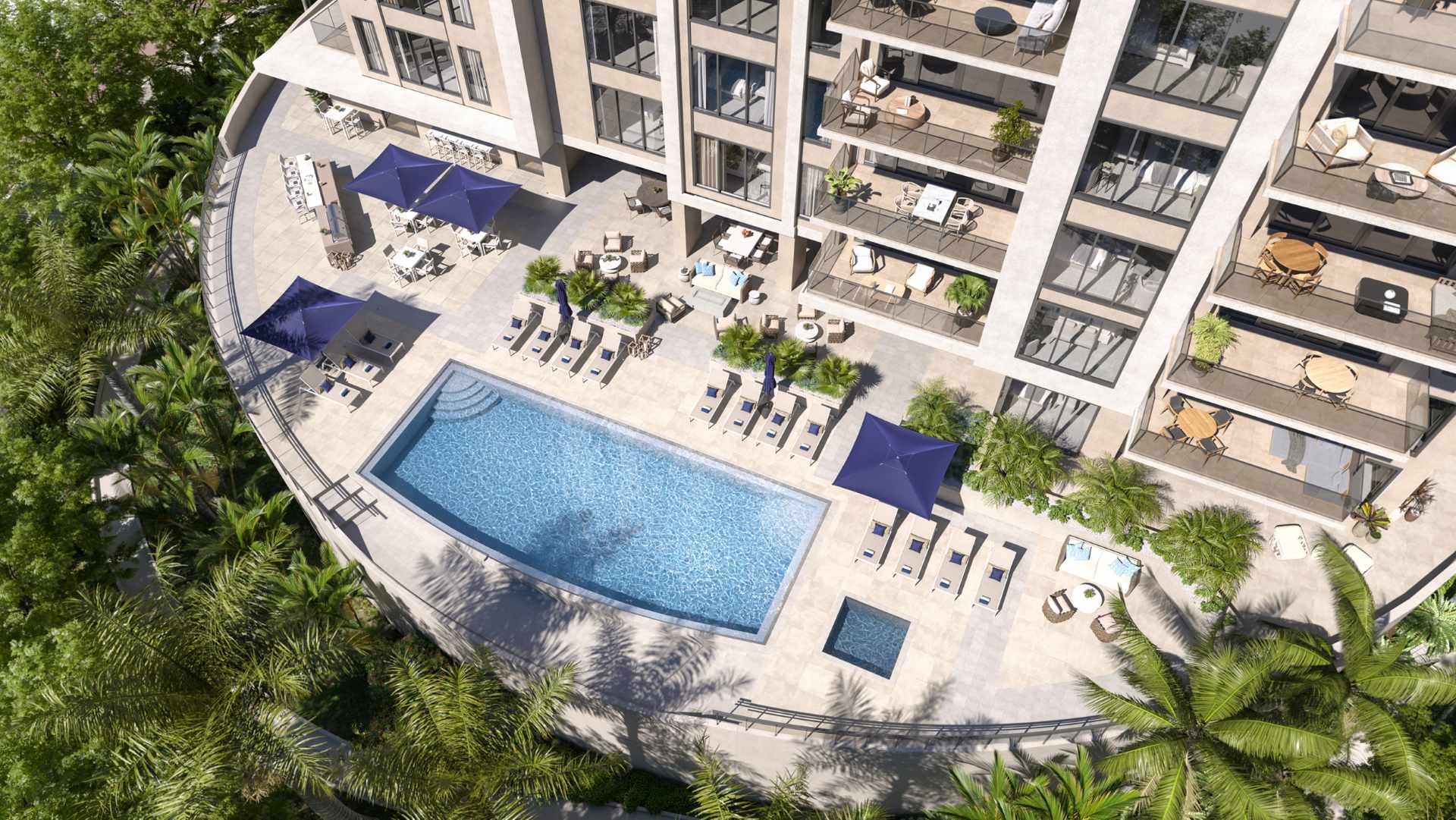 Aerial view of The Owen’s elevated pool deck with lounge seating, umbrellas, and landscaped surroundings in Sarasota.