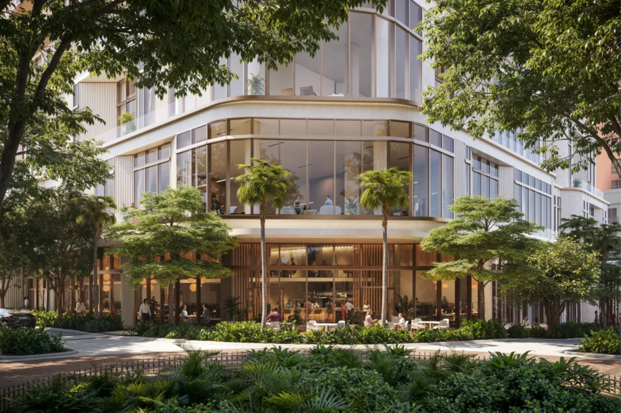Street-level exterior of Waldorf Astoria Residences Sarasota showcasing modern architecture, landscaped greenery, palm trees, and luxury residential entrance design