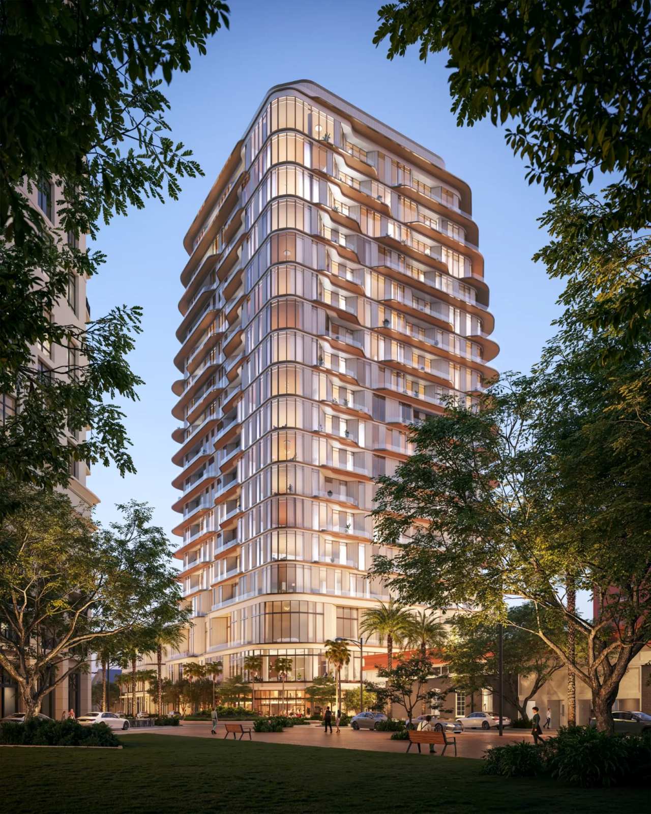 Waldorf Astoria Residences Sarasota luxury high-rise tower with modern glass architecture, curved balconies, and landscaped urban surroundings at sunset