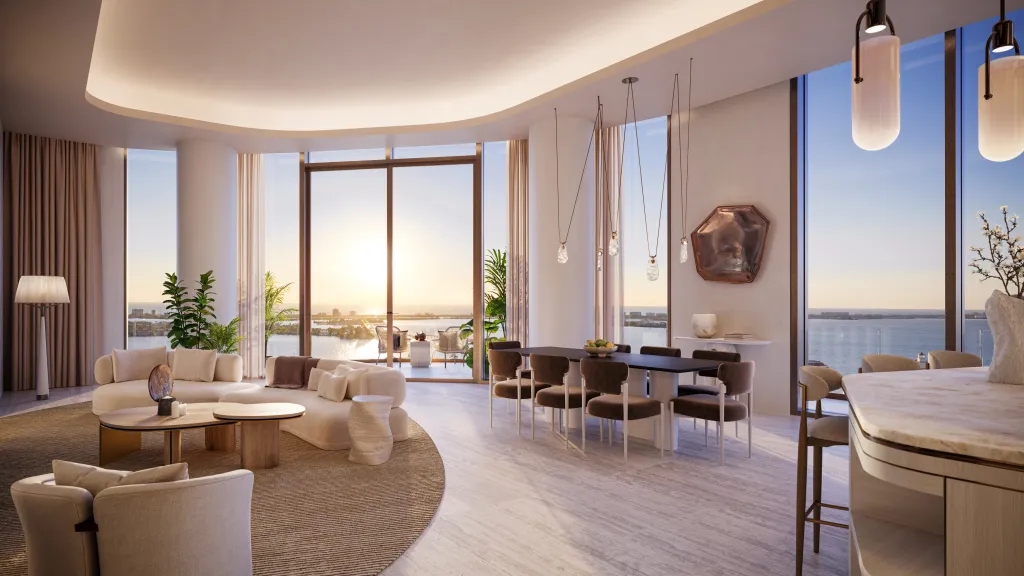 Open-concept living and dining area at Waldorf Astoria Residences Sarasota with floor-to-ceiling windows, waterfront views, designer furnishings, and natural light-filled interiors