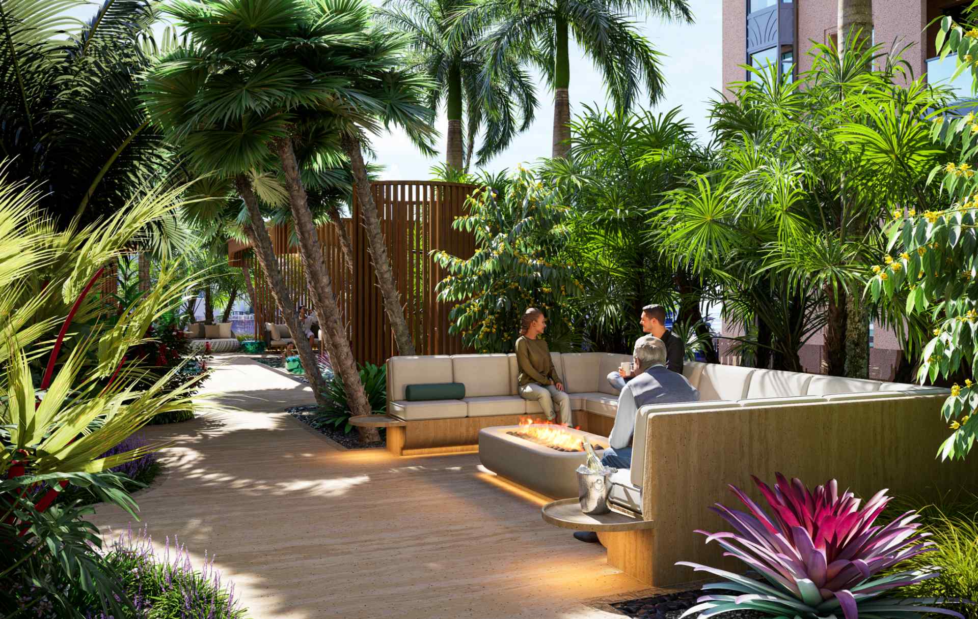 Outdoor lounge at Waldorf Astoria Residences Sarasota featuring fire pit seating, tropical landscaping, and private gathering spaces designed for luxury social living