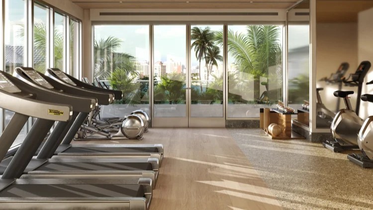 Modern fitness center with treadmills, strength equipment, and waterfront views at Peninsula Sarasota luxury condos