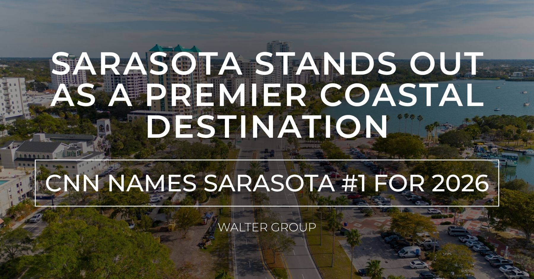 Aerial view of downtown Sarasota, Florida, with a newsroom graphic announcing CNN Travel's recognition of Sarasota as the #1 Best Town to Visit in America for 2026.